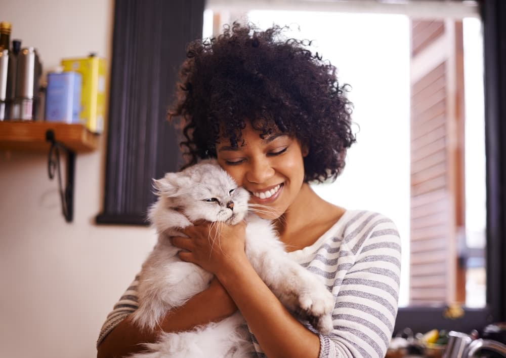Woman hugging cat